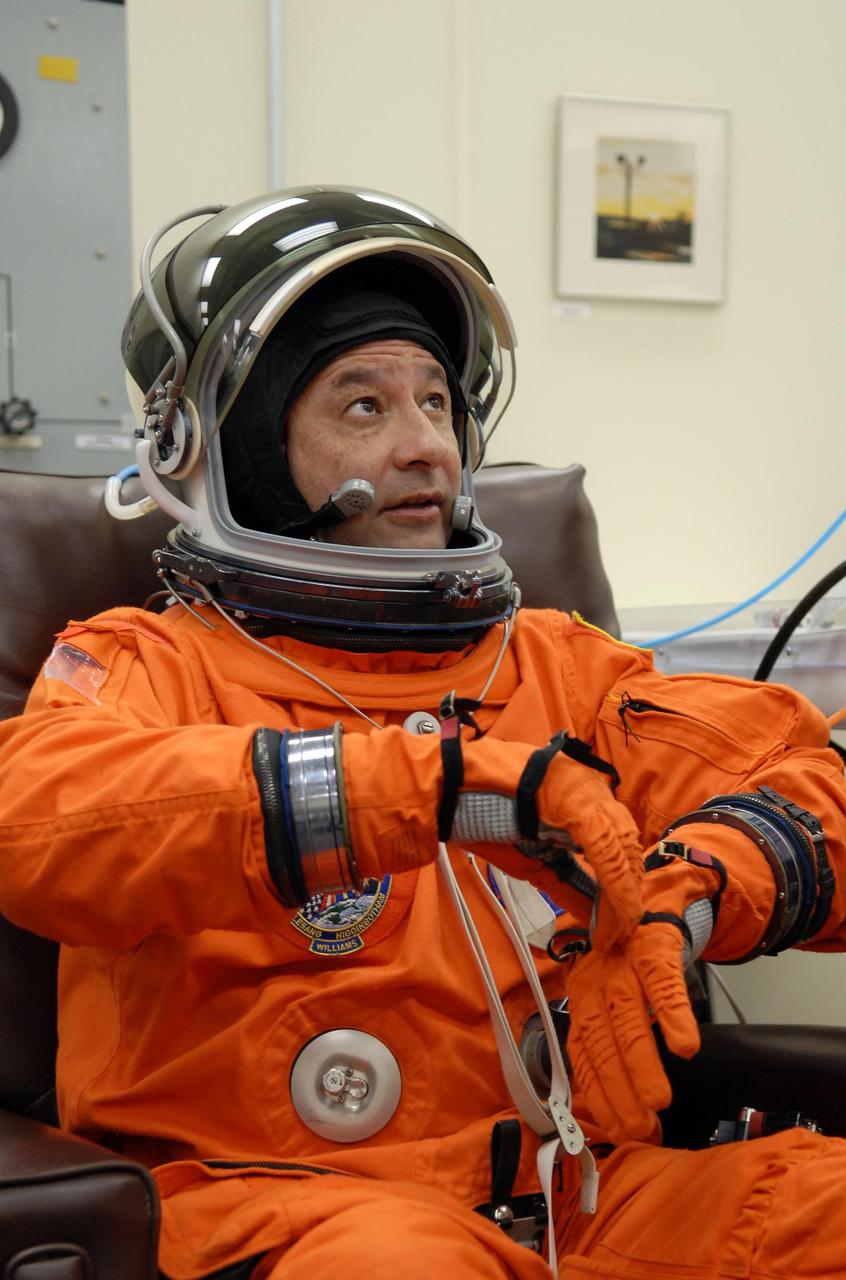 KENNEDY SPACE CENTER, FLA. --   The crew members of mission STS-116 are suiting up for a second launch attempt at 8:47 p.m. EST from Launch Pad 39B aboard Space Shuttle Discovery.   Here, Commander Mark Polansky adjusts his glove.  Polansky will be making his second shuttle flight. The first launch attempt of STS-116 on Dec. 7 was postponed due a low cloud ceiling over Kennedy Space Center. This is Discovery's 33rd mission and the first night launch since 2002.   The 20th shuttle mission to the International Space Station, STS-116 carries another truss segment, P5. It will serve as a spacer, mated to the P4 truss that was attached in September.  After installing the P5, the crew will reconfigure and redistribute the power generated by two pairs of U.S. solar arrays. Landing is expected Dec. 19 at KSC.   Photo credit: NASA/Kim Shiflett