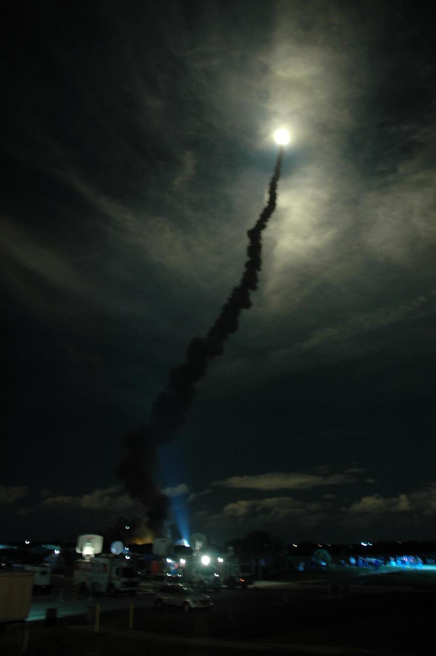KENNEDY SPACE CENTER, FLA. --   Flooding the night sky with light, Space Shuttle Discovery streaks through the clouds after liftoff from Launch Pad 39B on mission STS-116. The launch occurred at 8:47:35 p.m. EST.  This was the second launch attempt for mission STS-116.  The first launch attempt on Dec. 7 was postponed due a low cloud ceiling over Kennedy Space Center. This is Discovery's 33rd mission and the first night launch since 2002.   The 20th shuttle mission to the International Space Station, STS-116 carries another truss segment, P5. It will serve as a spacer, mated to the P4 truss that was attached in September.  After installing the P5, the crew will reconfigure and redistribute the power generated by two pairs of U.S. solar arrays. Landing is expected Dec. 21 at KSC.   Photo credit: NASA/Amanda Diller