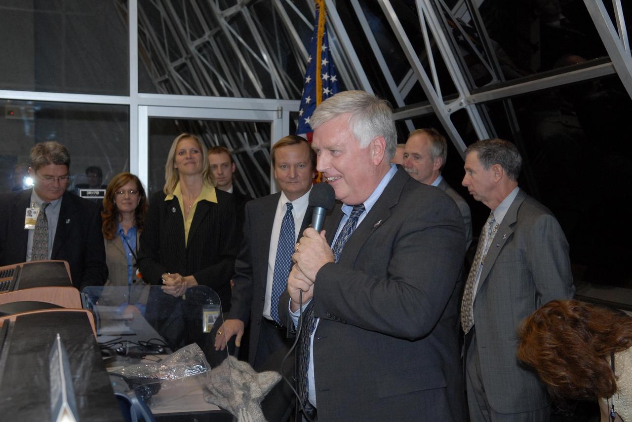 KENNEDY SPACE CENTER, FLA. --   In the firing room at the Launch Control Center, Kennedy Space Center Director Jim Kennedy (with microphone) congratulates the team for successful second launch attempt of Space Shuttle Discovery on mission STS-116. Liftoff occurred on time at 8:47 p.m. EST.  Others in the room are (left to right), Deputy Director Bill Parsons, External Relations Director Lisa Malone, NASA Flow Director for Discovery Stephanie Stilson, Shuttle Launch Director Mike Leinbach,  Associate Administrator for Space Operations Mission William Gerstenmaier and NASA  Administrator Mike Griffin.  The first launch attempt on Dec. 7 was postponed due a low cloud ceiling over Kennedy Space Center. This is Discovery's 33rd mission and the first night launch since 2002.   The 20th shuttle mission to the International Space Station, STS-116 carries another truss segment, P5. It will serve as a spacer, mated to the P4 truss that was attached in September.  After installing the P5, the crew will reconfigure and redistribute the power generated by two pairs of U.S. solar arrays. Landing is expected Dec. 21 at KSC.   Photo credit: NASA/Kim Shiflett