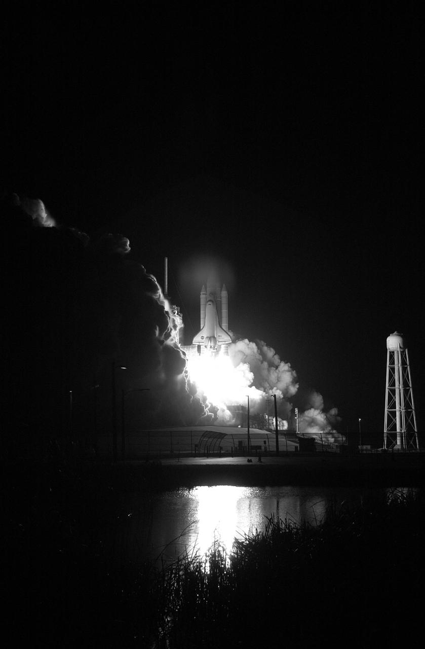 KENNEDY SPACE CENTER, FLA. -- The fiery liftoff of Space Shuttle Discovery from Launch Pad 39B on mission STS-116 is captured in the nearby water. Liftoff occurred on time at 8:47 p.m. EST. This was the second launch attempt of Discovery on mission STS-116.  The first launch attempt on Dec. 7 was postponed due a low cloud ceiling over Kennedy Space Center. This is Discovery's 33rd mission and the first night launch since 2002.   The 20th shuttle mission to the International Space Station, STS-116 carries another truss segment, P5. It will serve as a spacer, mated to the P4 truss that was attached in September.  After installing the P5, the crew will reconfigure and redistribute the power generated by two pairs of U.S. solar arrays. Landing is expected Dec. 21 at KSC.   Photo credit: NASA/Sandra Joseph, Robert Murray, Chris Lynch