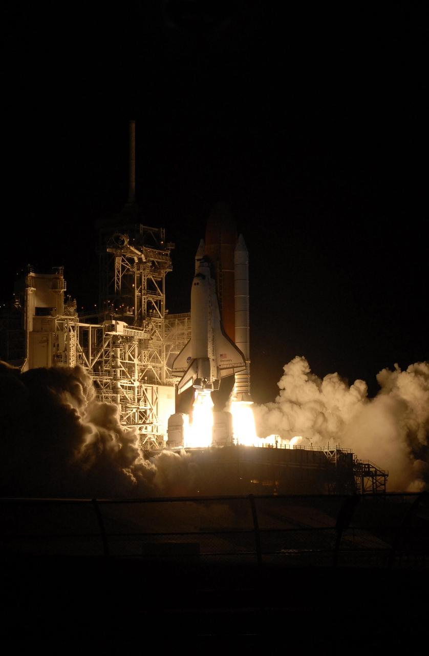KENNEDY SPACE CENTER, FLA. -- Space Shuttle Discovery seems to be standing on the fiery columns erupting from the solid rocket boosters as it lifts off Launch Pad 39B on mission STS-116.  Liftoff occurred on time at 8:47 p.m. EST. This was the second launch attempt of Discovery on mission STS-116.  The first launch attempt on Dec. 7 was postponed due a low cloud ceiling over Kennedy Space Center. This is Discovery's 33rd mission and the first night launch since 2002.   The 20th shuttle mission to the International Space Station, STS-116 carries another truss segment, P5. It will serve as a spacer, mated to the P4 truss that was attached in September.  After installing the P5, the crew will reconfigure and redistribute the power generated by two pairs of U.S. solar arrays. Landing is expected Dec. 21 at KSC.   Photo credit: NASA/Sandra Joseph, Robert Murray, Chris Lynch