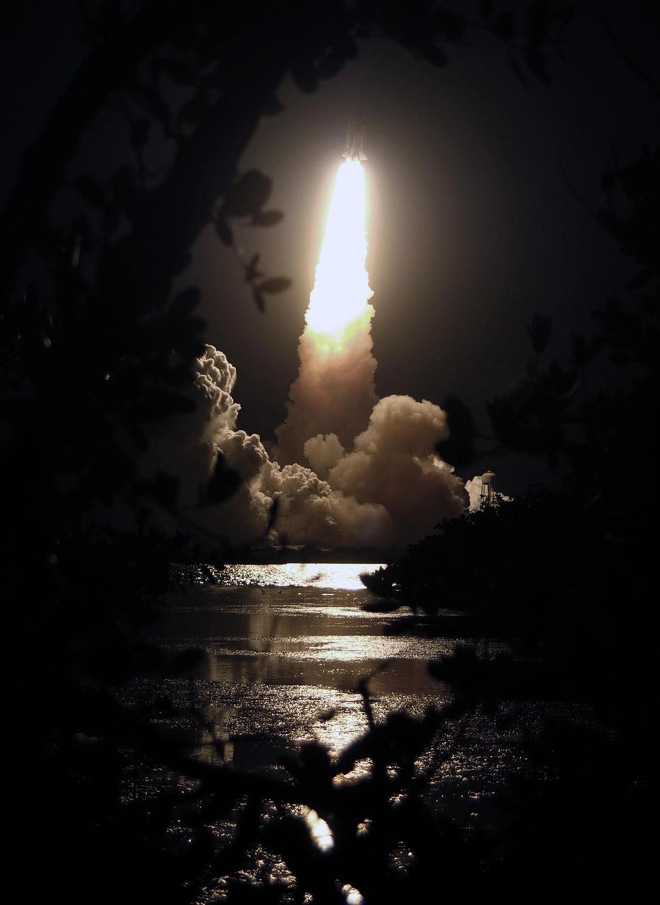 KENNEDY SPACE CENTER, FLA. --  Looking like a shooting star, Space Shuttle Discovery roars into the night sky on mission STS-116.  The trailing blaze lighted the sky and nearby water, while clouds of smoke and steam billowed across the launch pad.  Liftoff occurred on time at 8:47 p.m. EST. This was the second launch attempt for mission STS-116.  The first launch attempt on Dec. 7 was postponed due a low cloud ceiling over Kennedy Space Center. This is Discovery's 33rd mission and the first night launch since 2002.   The 20th shuttle mission to the International Space Station, STS-116 carries another truss segment, P5. It will serve as a spacer, mated to the P4 truss that was attached in September.  After installing the P5, the crew will reconfigure and redistribute the power generated by two pairs of U.S. solar arrays. Landing is expected Dec. 21 at KSC.   Photo courtesy of Nikon/Scott Andrews
