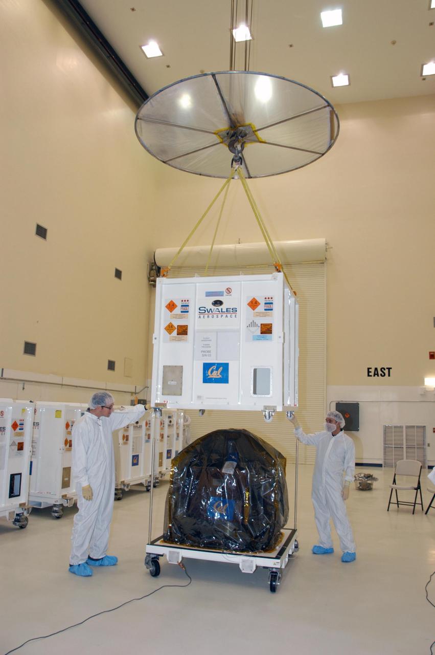 KENNEDY SPACE CENTER, FLA. --   With workers standing by at Astrotech Space Operations in Titusville, Fla., an overhead crane lifts the crate from one of the components of the recently arrived THEMIS spacecraft. THEMIS, which stands for Time History of Events and Macroscale Interactions during Substorms, comprises five identical probes that will study the dynamic and colorful eruptions of auroras. THEMIS is scheduled to  launch Feb. 15 from Cape Canaveral Air Force Station.  Photo credit: NASA/George Shelton