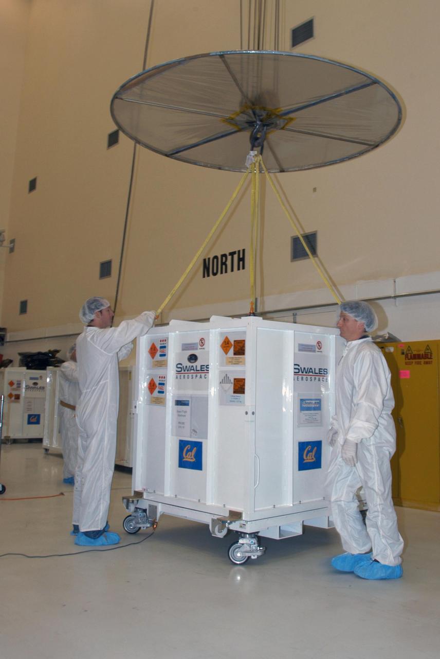 KENNEDY SPACE CENTER, FLA. -- At Astrotech Space Operations in Titusville, Fla., technicians release the overhead crane from the shipping container placed around one of the five THEMIS probes for its move to the hazardous processing facility. There the probes will be placed on a stand in preparation for fueling operations. Once fueling is complete, each probe will be weighed and individually mated to the payload carrier before pyrotechnics are installed. The fully integrated THEMIS payload is then ready for spin-balance testing and weighing. The final milestone is mating THEMIS to its upper stage booster. THEMIS consists of five identical probes, the largest number of scientific satellites ever launched into orbit aboard a single rocket. This unique constellation of satellites will resolve the tantalizing mystery of what causes the spectacular sudden brightening of the aurora borealis and aurora australis - the fiery skies over the Earth's northern and southern polar regions. These lights are the visible manifestations of invisible energy releases, called geomagnetic substorms, in near-Earth space. THEMIS will not only seek to answer where and when substorms start, but will also provide clues as to how and why these space storms create havoc on satellites, terrestrial power grids, and communication systems. THEMIS will be transported to Pad 17-B at Cape Canaveral Air Force Station on February 1 for mating to the Delta II rocket. Launch is scheduled for Feb. 15. Photo credit: NASA/George Shelton