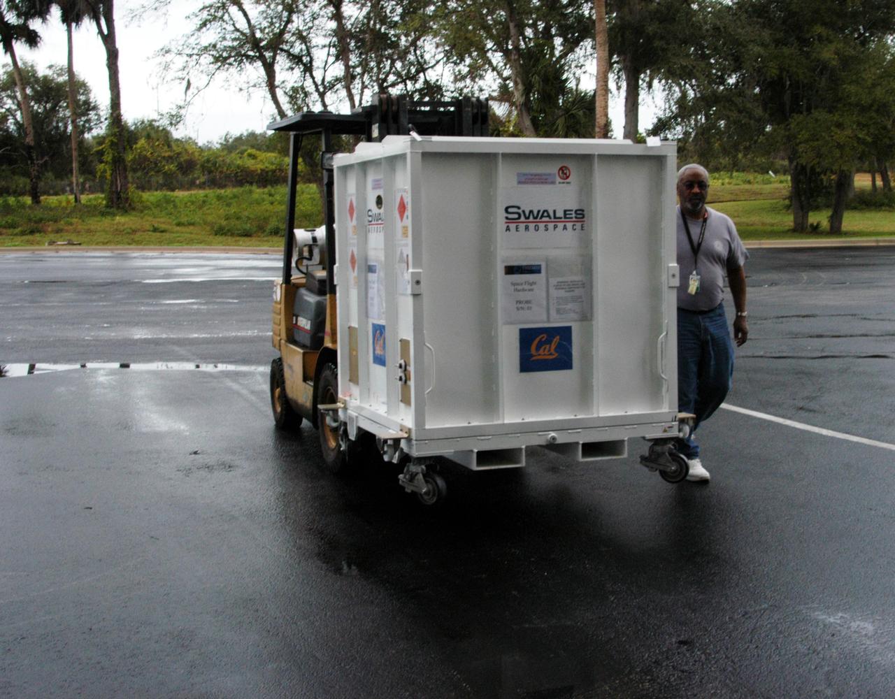 KENNEDY SPACE CENTER, FLA. -- One of the five THEMIS probes is being transported from Astrotech Space Operations in Titusville, Fla., to the hazardous processing facility. There the probes will be placed on a stand in preparation for fueling operations. Once fueling is complete, each probe will be weighed and individually mated to the payload carrier before pyrotechnics are installed. The fully integrated THEMIS payload is then ready for spin-balance testing and weighing. The final milestone is mating THEMIS to its upper stage booster. THEMIS consists of five identical probes, the largest number of scientific satellites ever launched into orbit aboard a single rocket. This unique constellation of satellites will resolve the tantalizing mystery of what causes the spectacular sudden brightening of the aurora borealis and aurora australis - the fiery skies over the Earth's northern and southern polar regions. These lights are the visible manifestations of invisible energy releases, called geomagnetic substorms, in near-Earth space. THEMIS will not only seek to answer where and when substorms start, but will also provide clues as to how and why these space storms create havoc on satellites, terrestrial power grids, and communication systems. THEMIS will be transported to Pad 17-B at Cape Canaveral Air Force Station on February 1 for mating to the Delta II rocket. Launch is scheduled for Feb. 15. Photo credit: NASA/George Shelton