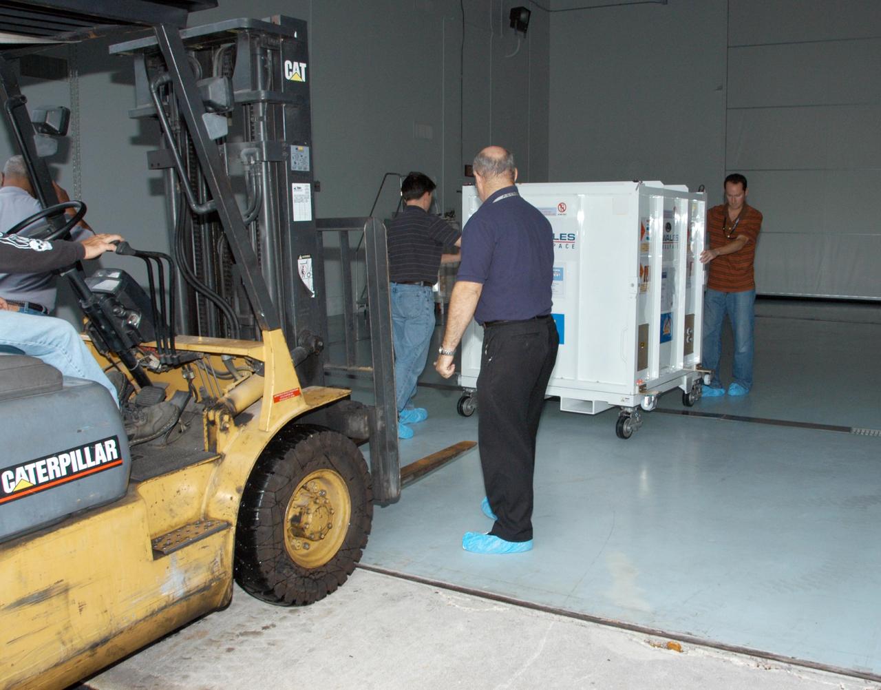 KENNEDY SPACE CENTER, FLA. -- One of the five THEMIS probes arrives at the hazardous processing facility after leaving Astrotech Space Operations in Titusville, Fla. At the facility, the probes will be placed on a stand in preparation for fueling operations. Once fueling is complete, each probe will be weighed and individually mated to the payload carrier before pyrotechnics are installed. The fully integrated THEMIS payload is then ready for spin-balance testing and weighing. The final milestone is mating THEMIS to its upper stage booster. THEMIS consists of five identical probes, the largest number of scientific satellites ever launched into orbit aboard a single rocket. This unique constellation of satellites will resolve the tantalizing mystery of what causes the spectacular sudden brightening of the aurora borealis and aurora australis - the fiery skies over the Earth's northern and southern polar regions. These lights are the visible manifestations of invisible energy releases, called geomagnetic substorms, in near-Earth space. THEMIS will not only seek to answer where and when substorms start, but will also provide clues as to how and why these space storms create havoc on satellites, terrestrial power grids, and communication systems. THEMIS will be transported to Pad 17-B at Cape Canaveral Air Force Station on February 1 for mating to the Delta II rocket. Launch is scheduled for Feb. 15. Photo credit: NASA/George Shelton