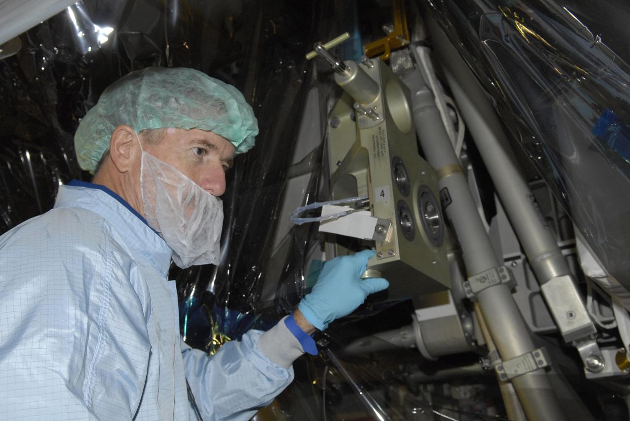 KENNEDY SPACE CENTER, FLA. -- In the Space Station Processing Facility, STS-117 Mission Specialist James Reilly examines the S3/S4 Integrated Truss Segment during Crew Equipment Interface Test (CEIT) activities. A CEIT provides the astronauts opportunities to become familiar with equipment and hardware with which they will be working during their mission. The crew of mission STS-117 will deliver and install the second and third starboard truss segments (S3/S4) and another pair of solar arrays and batteries during the Space Shuttle Program's 21st mission to the International Space Station. Launch of Space Shuttle Atlantis is scheduled for March 2007. Photo credit: NASA/Kim Shiflett