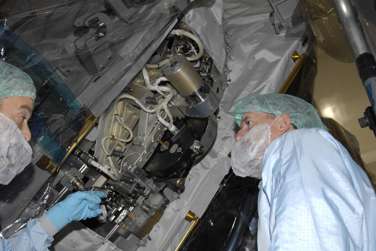 KENNEDY SPACE CENTER, FLA. -- In the Space Station Processing Facility, a technician points out elements of the S3/S4 Integrated Truss Segment to STS-117 Mission Specialist James Reilly (right) during Crew Equipment Interface Test (CEIT) activities. A CEIT provides the astronauts opportunities to become familiar with equipment and hardware with which they will be working during their mission. The crew of mission STS-117 will deliver and install the second and third starboard truss segments (S3/S4) and another pair of solar arrays and batteries during the Space Shuttle Program's 21st mission to the International Space Station. Launch of Space Shuttle Atlantis is scheduled for March 2007. Photo credit: NASA/Kim Shiflett