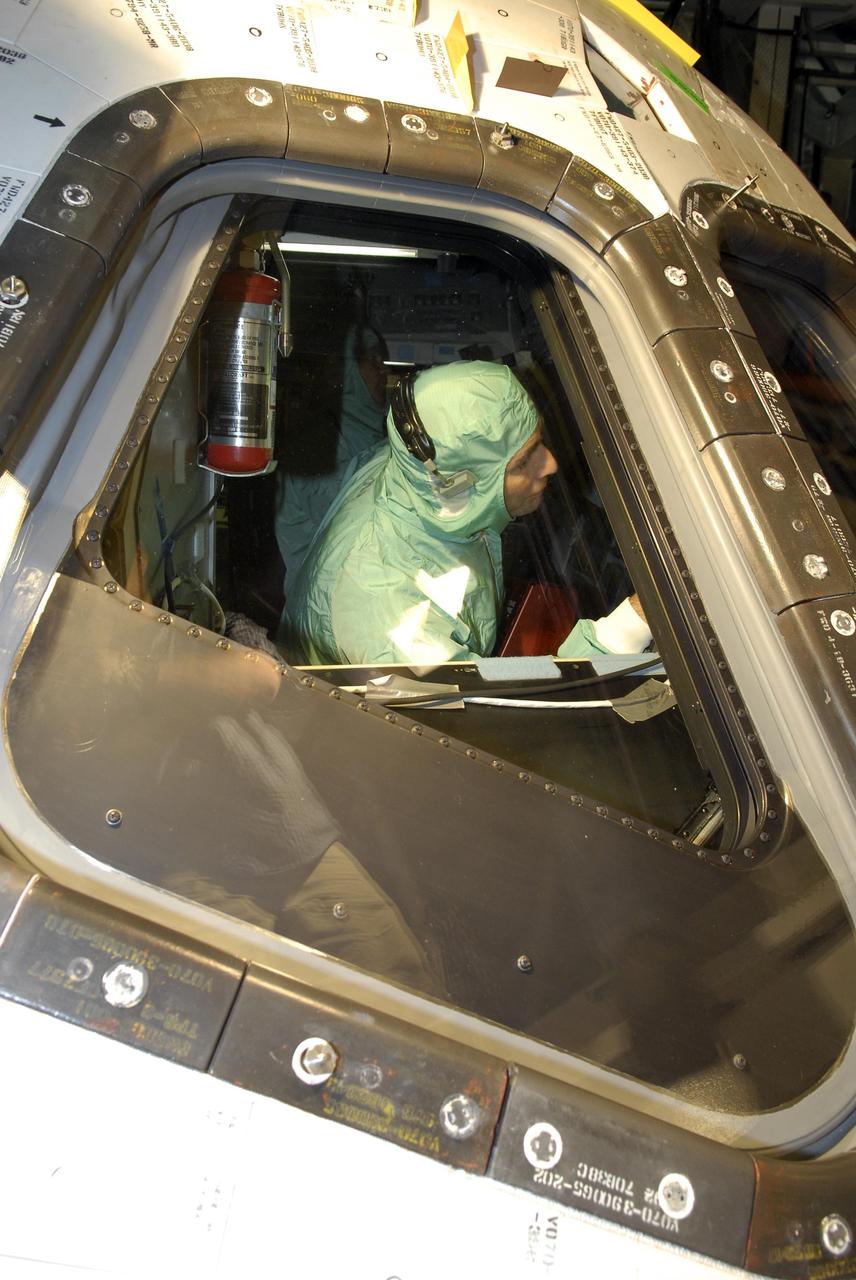 KENNEDY SPACE CENTER, FLA. -- In the Orbiter Processing Facility, STS-117 Pilot Lee Archambault checks out the cockpit of the orbiter Atlantis, the vehicle for the mission.  He and other crew members are at KSC to take part in a Crew Equipment Interface Test that allows them opportunities to become familiar with equipment and hardware for their mission. STS-117 will deliver the S3/S4 and another pair of solar arrays to the space station.  The 21st shuttle mission to the International Space Station, STS-117 is scheduled to launch no earlier than March 16.  Photo credit: NASA/Kim Shiflett