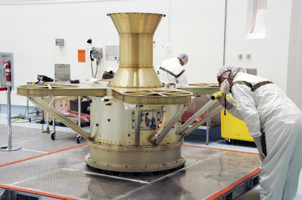 KENNEDY SPACE CENTER, FLA. -- At Astrotech Space Operations in Titusville, Fla., a worker examines connections on the THEMIS spacecraft, which is expected to be fueled Jan. 3-5. THEMIS consists of five identical probes, the largest number of scientific satellites ever launched into orbit aboard a single rocket. This unique constellation of satellites will resolve the tantalizing mystery of what causes the spectacular sudden brightening of the aurora borealis and aurora australis - the fiery skies over the Earth's northern and southern polar regions. THEMIS is scheduled to launch Feb. 15 from Cape Canaveral Air Force Station. Photo credit: NASA/George Shelton