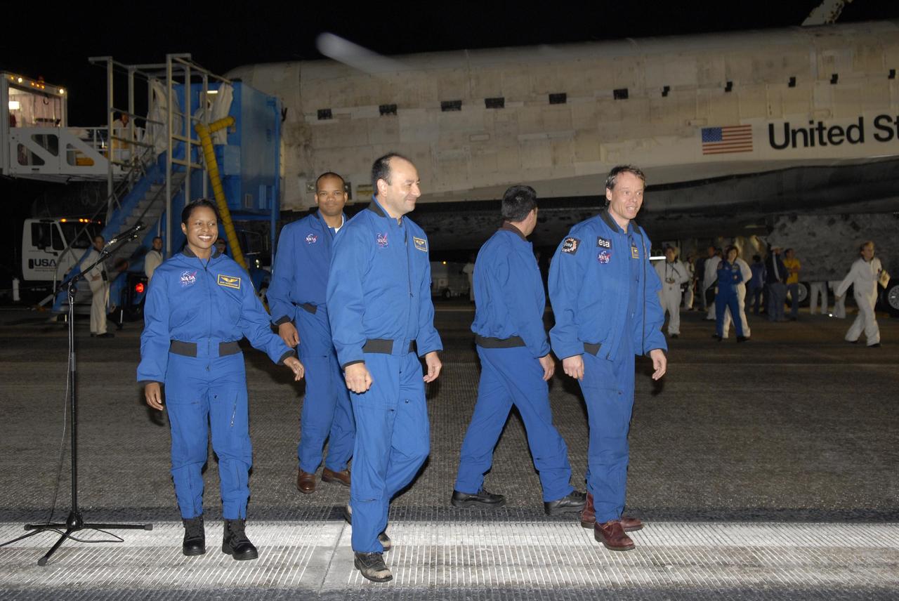 KENNEDY SPACE CENTER, FLA. --  Members of the STS-116 crew head for crew quarters following the landing of Discovery on Runway 15 at NASA Kennedy Space Center's Shuttle Landing Facility. From left are Mission Specialists Joan Higginbotham and Robert Curbeam, Commander Mark Polansky, Pilot William Oefelein and Mission Specialist Christer Fuglesang, who represents the European Space Agency. Other astronauts aboard Discovery not shown are Mission Specialist Nicholas Patrick and European Space Agency astronaut Thomas Reiter, who is returning from a 6-month stay on the International Space Station. During the mission, three spacewalks attached the P5 integrated truss structure to the station, and completed the rewiring of the orbiting laboratory's power system.  A fourth spacewalk retracted a stubborn solar array. Main gear touchdown was at 5:32 p.m. EST. Nose gear touchdown was at 5:32:12 p.m. and wheel stop was at 5:32:52 p.m.  At touchdown -- nominally about 2,500 ft. beyond the runway threshold -- the orbiter is traveling at a speed ranging from 213 to 226 mph. Discovery traveled 5,330,000 miles, landing on orbit 204. Mission elapsed time was 12 days, 20 hours, 44 minutes and 16 seconds. This is the 64th landing at KSC. Photo credit: NASA/Kim Shiflett