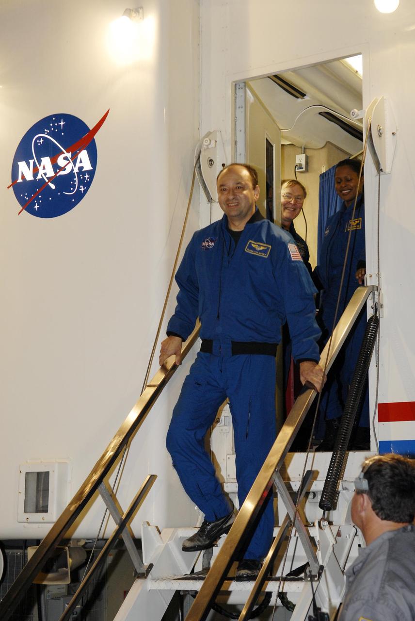 KENNEDY SPACE CENTER, FLA. -- STS-116 Commander Mark Polansky disembarks from Space Shuttle Discovery following landing on Runway 15 at NASA Kennedy Space Center's Shuttle Landing Facility, as his fellow astronauts await their turns. During the STS-116 mission, three spacewalks attached the P5 integrated truss structure to the station, and completed the rewiring of the orbiting laboratory's power system. A fourth spacewalk retracted a stubborn solar array. Main gear touchdown was at 5:32 p.m. EST. Nose gear touchdown was at 5:32:12 p.m. and wheel stop was at 5:32:52 p.m. At touchdown -- nominally about 2,500 ft. beyond the runway threshold -- the orbiter is traveling at a speed ranging from 213 to 226 mph. Discovery traveled 5,330,000 miles, landing on orbit 204. Mission elapsed time was 12 days, 20 hours, 44 minutes and 16 seconds. This is the 64th landing at KSC. Photo credit: NASA/Kim Shiflett