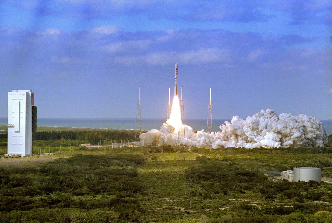 KENNEDY SPACE CENTER, FLA. — With the blue Atlantic Ocean as backdrop, smoke and steam fill the launch pad, at right, as NASA’s New Horizons spacecraft roars into the sky aboard an Atlas V rocket. Liftoff was on time at 2 p.m. EST from Complex 41 on Cape Canaveral Air Force Station in Florida. This was the third launch attempt in as many days after scrubs due to weather concerns. The compact, 1,050-pound piano-sized probe will get a boost from a kick-stage solid propellant motor for its journey to Pluto. New Horizons will be the fastest spacecraft ever launched, reaching lunar orbit distance in just nine hours and passing Jupiter 13 months later. The New Horizons science payload, developed under direction of Southwest Research Institute, includes imaging infrared and ultraviolet spectrometers, a multi-color camera, a long-range telescopic camera, two particle spectrometers, a space-dust detector and a radio science experiment. The dust counter was designed and built by students at the University of Colorado, Boulder. The launch at this time allows New Horizons to fly past Jupiter in early 2007 and use the planet’s gravity as a slingshot toward Pluto. The Jupiter flyby trims the trip to Pluto by as many as five years and provides opportunities to test the spacecraft’s instruments and flyby capabilities on the Jupiter system. New Horizons could reach the Pluto system as early as mid-2015, conducting a five-month-long study possible only from the close-up vantage of a spacecraft.