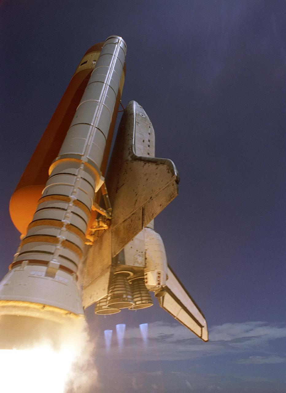 KENNEDY SPACE CENTER, FLA. - Making history with the first-ever launch on Independence Day, Space Shuttle Discovery rockets into the blue sky on mission STS-121, trailing fiery exhaust and blue mach diamonds from the main engine nozzles. Liftoff was on-time at 2:38 p.m. EDT. During the 12-day mission, the STS-121 crew of seven will test new equipment and procedures to improve shuttle safety, as well as deliver supplies and make repairs to the International Space Station. Landing is scheduled for July 16 or 17 at Kennedy's Shuttle Landing Facility. Photo credit: NASA/Regina Mitchell-Ryall & Don Kight