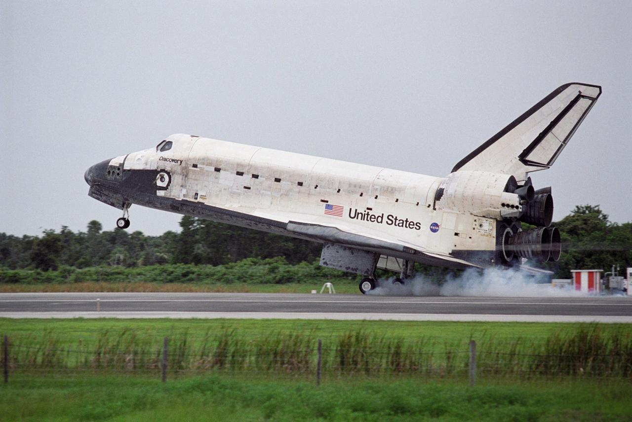 KENNEDY SPACE CENTER, FLA. - The orbiter Discovery approaches touchdown on Runway 15 at NASA's Shuttle Landing Facility, completing mission STS-121 to the International Space Station. Discovery traveled 5.3 million miles, landing on orbit 202. Mission elapsed time was 12 days, 18 hours, 37 minutes and 54 seconds. Main gear touchdown occurred on time at 9:14:43 EDT. Wheel stop was at 9:15:49 EDT. The returning crew members aboard are Commander Steven Lindsey, Pilot Mark Kelly and Mission Specialists Piers Sellers, Michael Fossum, Lisa Nowak and Stephanie Wilson. Mission Specialist Thomas Reiter, who launched with the crew on July 4, remained on the station to join the Expedition 13 crew there. The landing is the 62nd at Kennedy Space Center and the 32nd for Discovery. During the mission, the STS-121 crew tested new equipment and procedures to improve shuttle safety, and delivered supplies and made repairs to the International Space Station. Photo credit: NASA/Rick Wetherington