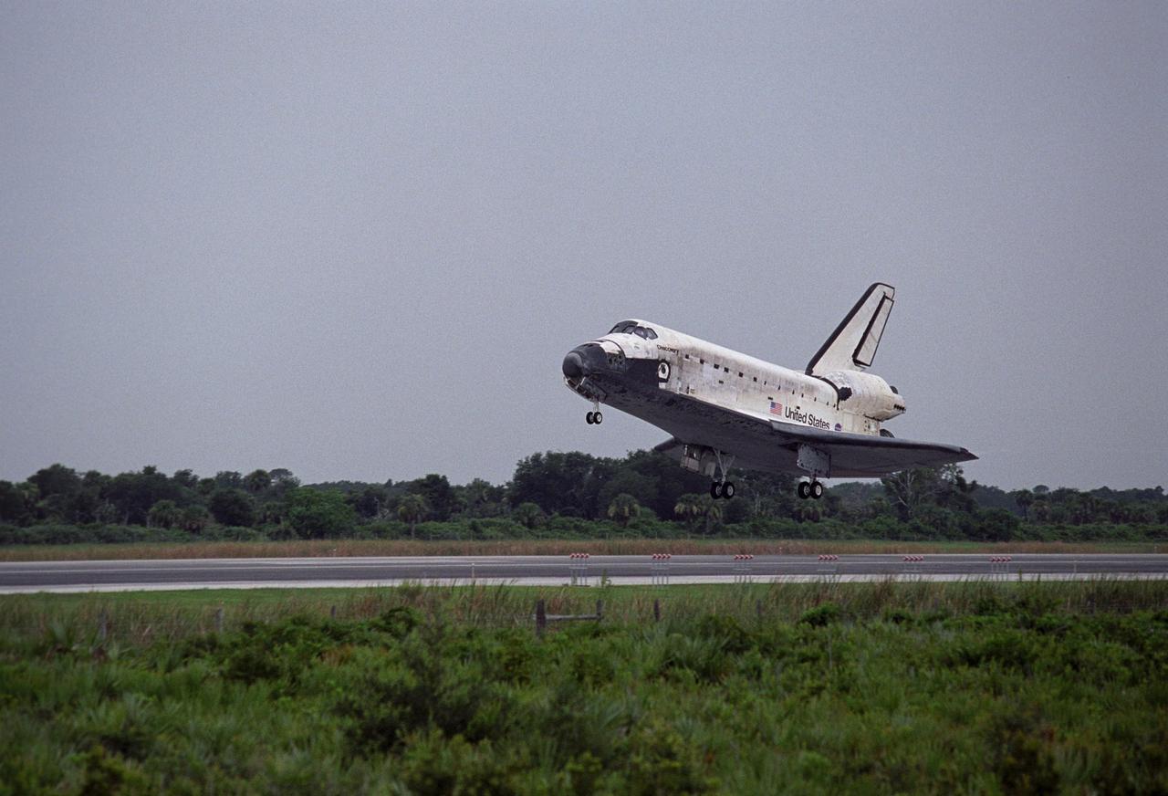 KENNEDY SPACE CENTER, FLA. - The orbiter Discovery's main landing gear kick up dust as they touch down on Runway 15 at NASA's Shuttle Landing Facility, completing mission STS-121 to the International Space Station.Discovery traveled 5.3 million miles, landing on orbit 202. Mission elapsed time was 12 days, 18 hours, 37 minutes and 54 seconds. Main gear touchdown occurred on time at 9:14:43 EDT. Wheel stop was at 9:15:49 EDT. The returning crew members aboard are Commander Steven Lindsey, Pilot Mark Kelly and Mission Specialists Piers Sellers, Michael Fossum, Lisa Nowak and Stephanie Wilson. Mission Specialist Thomas Reiter, who launched with the crew on July 4, remained on the station to join the Expedition 13 crew there. The landing is the 62nd at Kennedy Space Center and the 32nd for Discovery. During the mission, the STS-121 crew tested new equipment and procedures to improve shuttle safety, and delivered supplies and made repairs to the International Space Station. Photo credit: NASA/Rick Wetherington