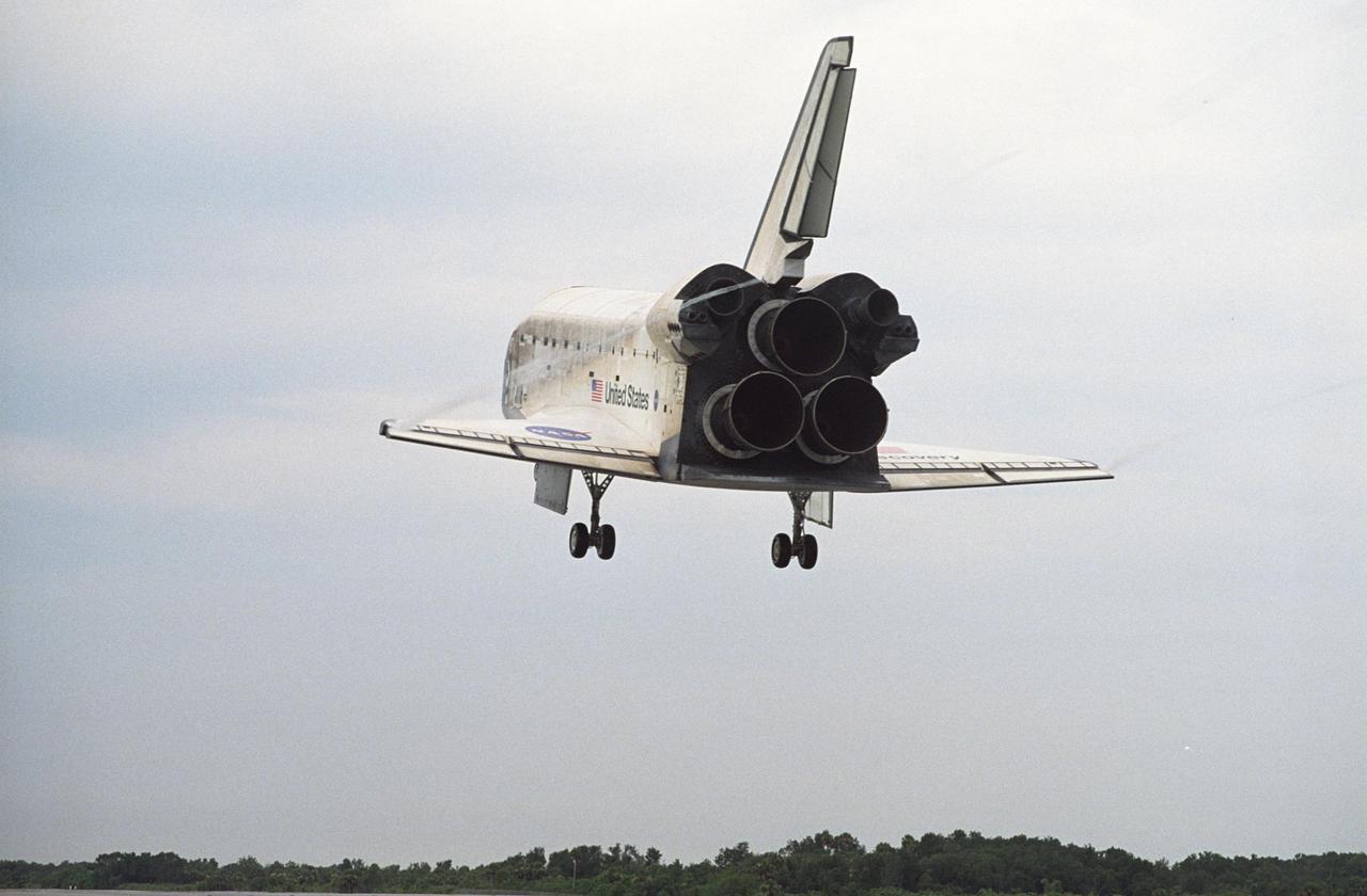 KENNEDY SPACE CENTER, FLA. - Vapor trails flow from Discovery's wing tips as it makes a speedy approach to Runway 15 at NASA's Shuttle Landing Facility, completing mission STS-121 to the International Space Station. At touchdown -- nominally about 2,500 ft. beyond the runway threshold -- the orbiter is traveling at a speed ranging from 213 to 226 mph. Discovery traveled 5.3 million miles, landing on orbit 202. Mission elapsed time was 12 days, 18 hours, 37 minutes and 54 seconds. Main gear touchdown occurred on time at 9:14:43 EDT. Wheel stop was at 9:15:49 EDT. The returning crew members aboard are Commander Steven Lindsey, Pilot Mark Kelly and Mission Specialists Piers Sellers, Michael Fossum, Lisa Nowak and Stephanie Wilson. Mission Specialist Thomas Reiter, who launched with the crew on July 4, remained on the station to join the Expedition 13 crew there. The landing is the 62nd at Kennedy Space Center and the 32nd for Discovery. During the mission, the STS-121 crew tested new equipment and procedures to improve shuttle safety, and delivered supplies and made repairs to the International Space Station. Photo credit: NASA/Tony Gray & Tim Powers
