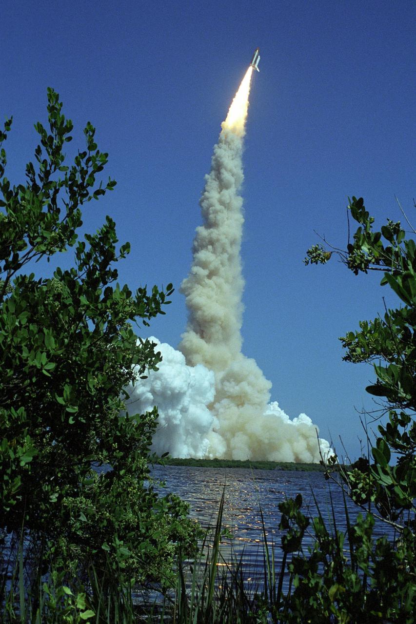 KENNEDY SPACE CENTER, FLA. -  Trailing fire and a plume of smoke, Space Shuttle Atlantis leaves a dance of lights on nearby water as it hurtles toward space for a rendezvous with the International Space Station on mission STS-115.  Liftoff was on-time at 11:14:55 a.m. EDT. After several launch attempts were scrubbed due to weather and technical concerns, this launch was executed perfectly. Mission STS-115 is the 116th space shuttle flight, the 27th flight for orbiter Atlantis, and the 19th U.S. flight to the International Space Station.  During the mission, Atlantis' astronauts will deliver and install the 17.5-ton, bus-sized P3/P4 integrated truss segment on the station. The girder-like truss includes a set of giant solar arrays, batteries and associated electronics and will provide one-fourth of the total power-generation capability for the completed station. STS-115 is scheduled to last 11 days with a planned landing at KSC