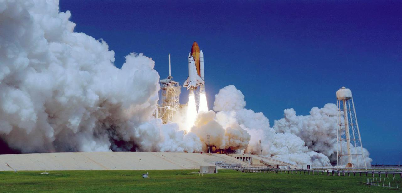 KENNEDY SPACE CENTER, FLA. -   Space Shuttle Atlantis hurtles toward space, propelled by twin columns of fire from the solid rocket boosters.  Clouds of smoke and steam spread side to side across Launch Pad 39B.  Atlantis is heading for a rendezvous with the International Space Station on mission STS-115.  Liftoff was on-time at 11:14:55 a.m. EDT. After several launch attempts were scrubbed due to weather and technical concerns, this launch was executed perfectly. Mission STS-115 is the 116th space shuttle flight, the 27th flight for orbiter Atlantis, and the 19th U.S. flight to the International Space Station.  During the mission, Atlantis' astronauts will deliver and install the 17.5-ton, bus-sized P3/P4 integrated truss segment on the station. The girder-like truss includes a set of giant solar arrays, batteries and associated electronics and will provide one-fourth of the total power-generation capability for the completed station. STS-115 is scheduled to last 11 days with a planned landing at KSC