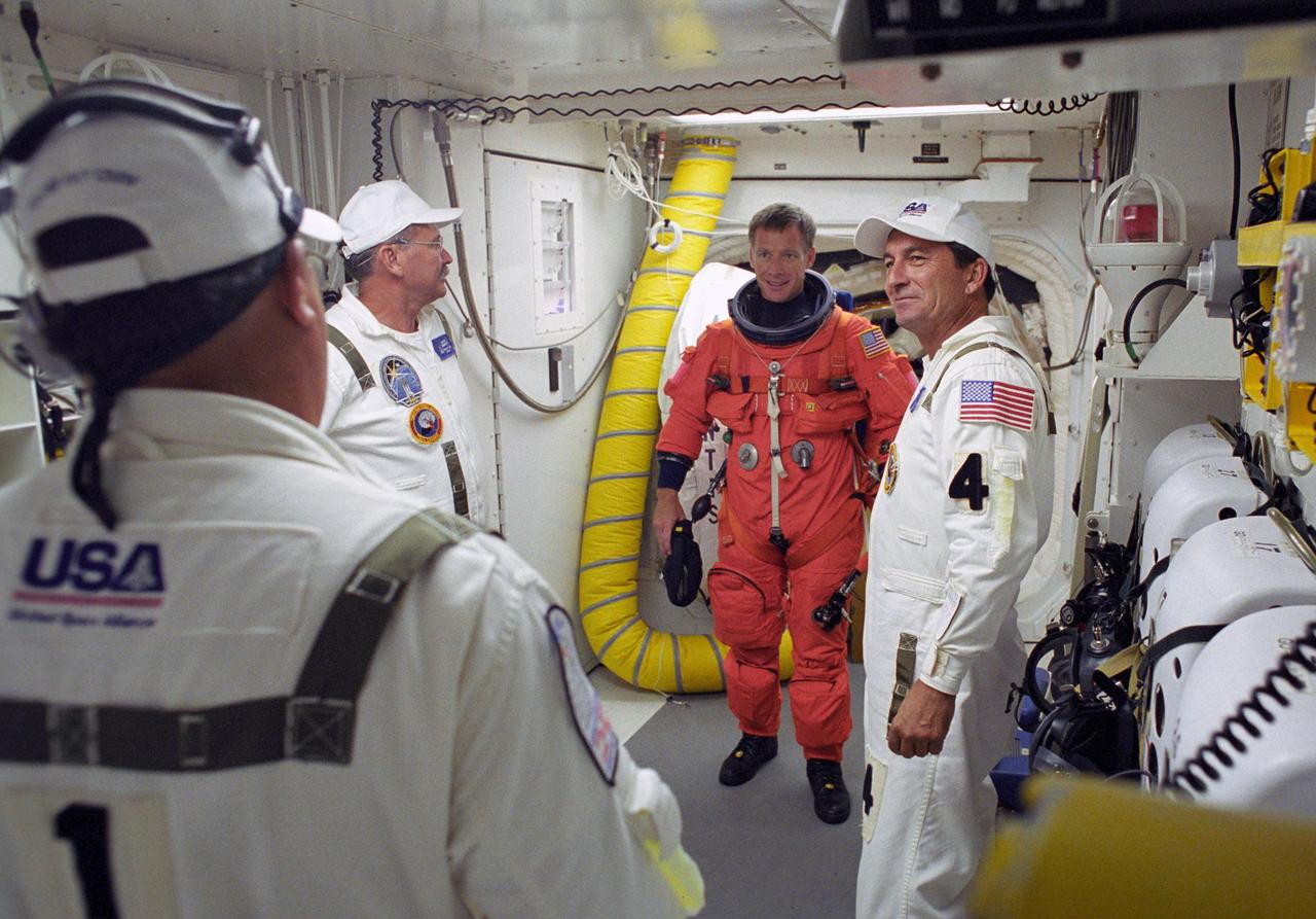 KENNEDY SPACE CENTER, FLA. -    In the White Room on Launch Pad 39B, STS-115 Pilot Christopher Ferguson talks with the closeout crew before entering Space Shuttle Atlantis. Ferguson is making his first shuttle flight.  During the mission, Atlantis' astronauts will deliver and install the 17.5-ton, bus-sized P3/P4 integrated truss segment on the station. The girder-like truss includes a set of giant solar arrays, batteries and associated electronics and will provide one-fourth of the total power-generation capability for the completed station. This mission is the 116th space shuttle flight, the 27th flight for orbiter Atlantis, and the 19th U.S. flight to the International Space Station.  STS-115 is scheduled to last 11 days with a planned landing at KSC.