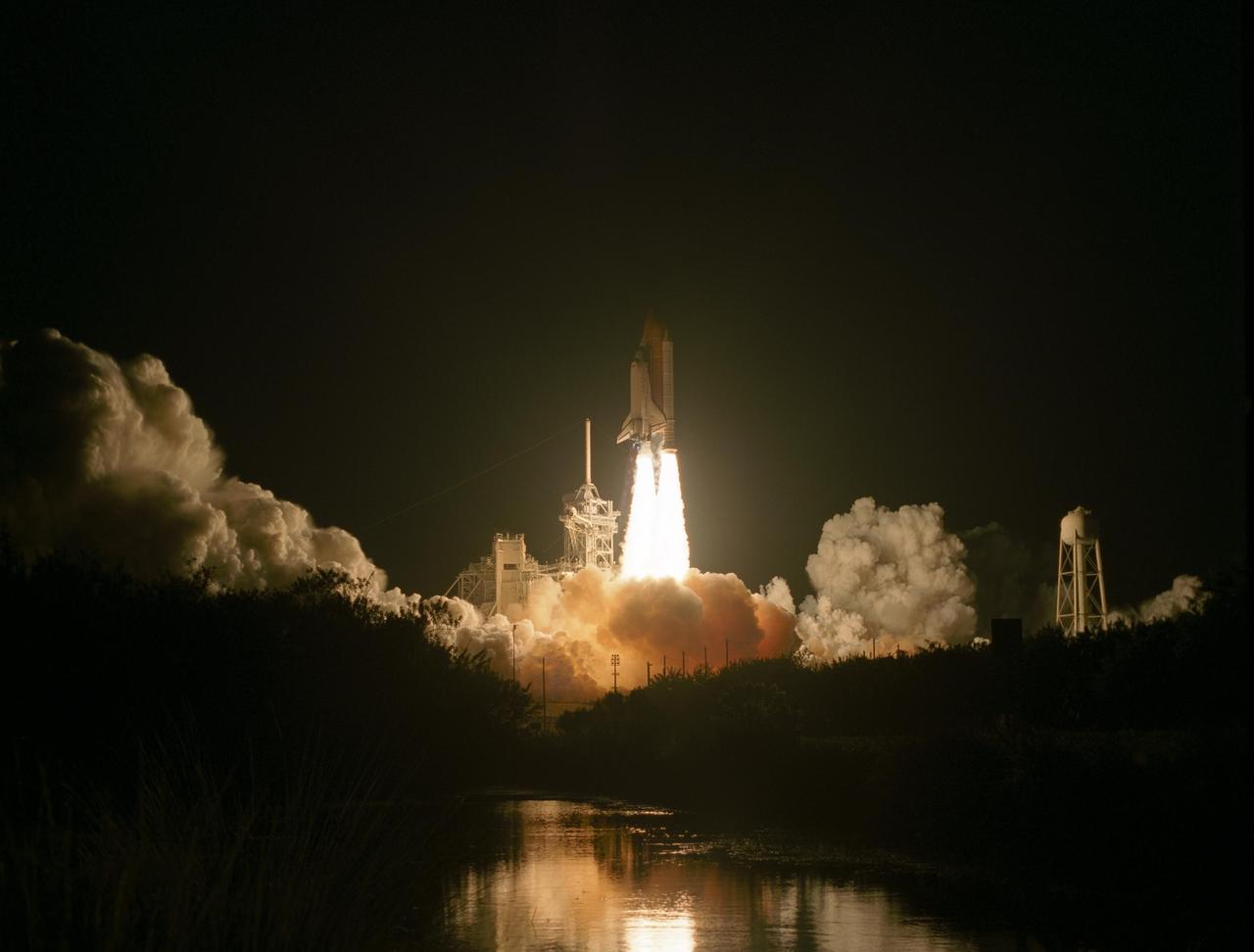 KENNEDY SPACE CENTER, FLA. --   Rising on columns of fire from amid the smoke and steam below, Space Shuttle Discovery leaps toward the sky past the lightning mast on Launch Pad 39B on mission STS-116.  Liftoff occurred on time at 8:47 p.m. EST. This was the second launch attempt of Discovery on mission STS-116.  The first launch attempt on Dec. 7 was postponed due a low cloud ceiling over Kennedy Space Center. This is Discovery's 33rd mission and the first night launch since 2002.   The 20th shuttle mission to the International Space Station, STS-116 carries another truss segment, P5. It will serve as a spacer, mated to the P4 truss that was attached in September.  After installing the P5, the crew will reconfigure and redistribute the power generated by two pairs of U.S. solar arrays. Landing is expected Dec. 21 at KSC.   Photo credit: NASA/Sandra Joseph, Robert Murray, Chris Lynch