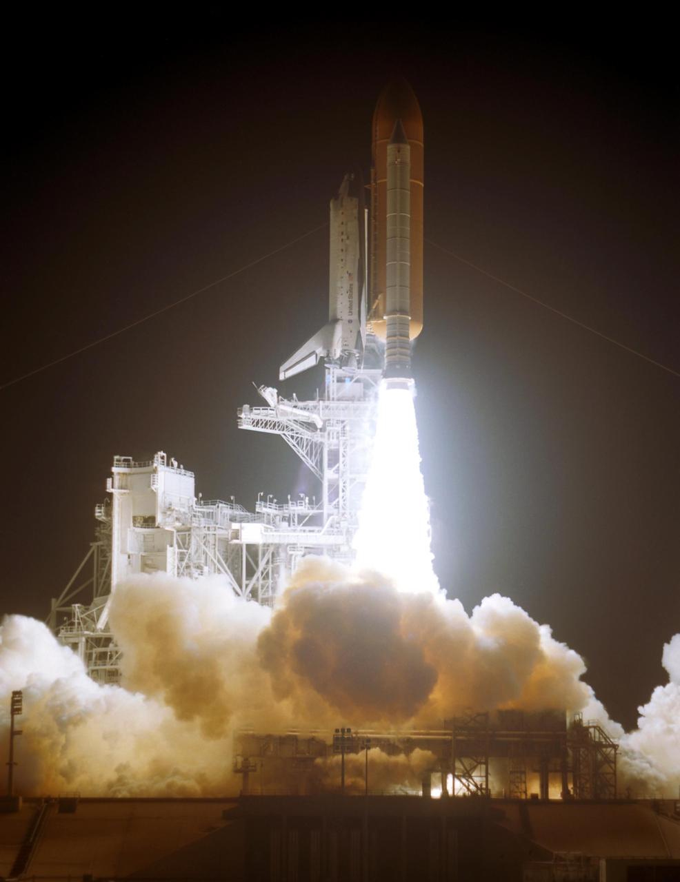 KENNEDY SPACE CENTER, FLA. --   Rising on columns of fire above the smoke and steam below, Space Shuttle Discovery leaps toward the sky past the lightning mast on Launch Pad 39B on mission STS-116.  Liftoff occurred at 8:47 p.m. EST. This was the second launch attempt for mission STS-116.  The first launch attempt on Dec. 7 was postponed due a low cloud ceiling over Kennedy Space Center. This is Discovery's 33rd mission and the first night launch since 2002.   The 20th shuttle mission to the International Space Station, STS-116 carries another truss segment, P5. It will serve as a spacer, mated to the P4 truss that was attached in September.  After installing the P5, the crew will reconfigure and redistribute the power generated by two pairs of U.S. solar arrays. Landing is expected Dec. 21 at KSC.   Photo credit: NASA/Regina Mitchell-Ryall & Tim Powers