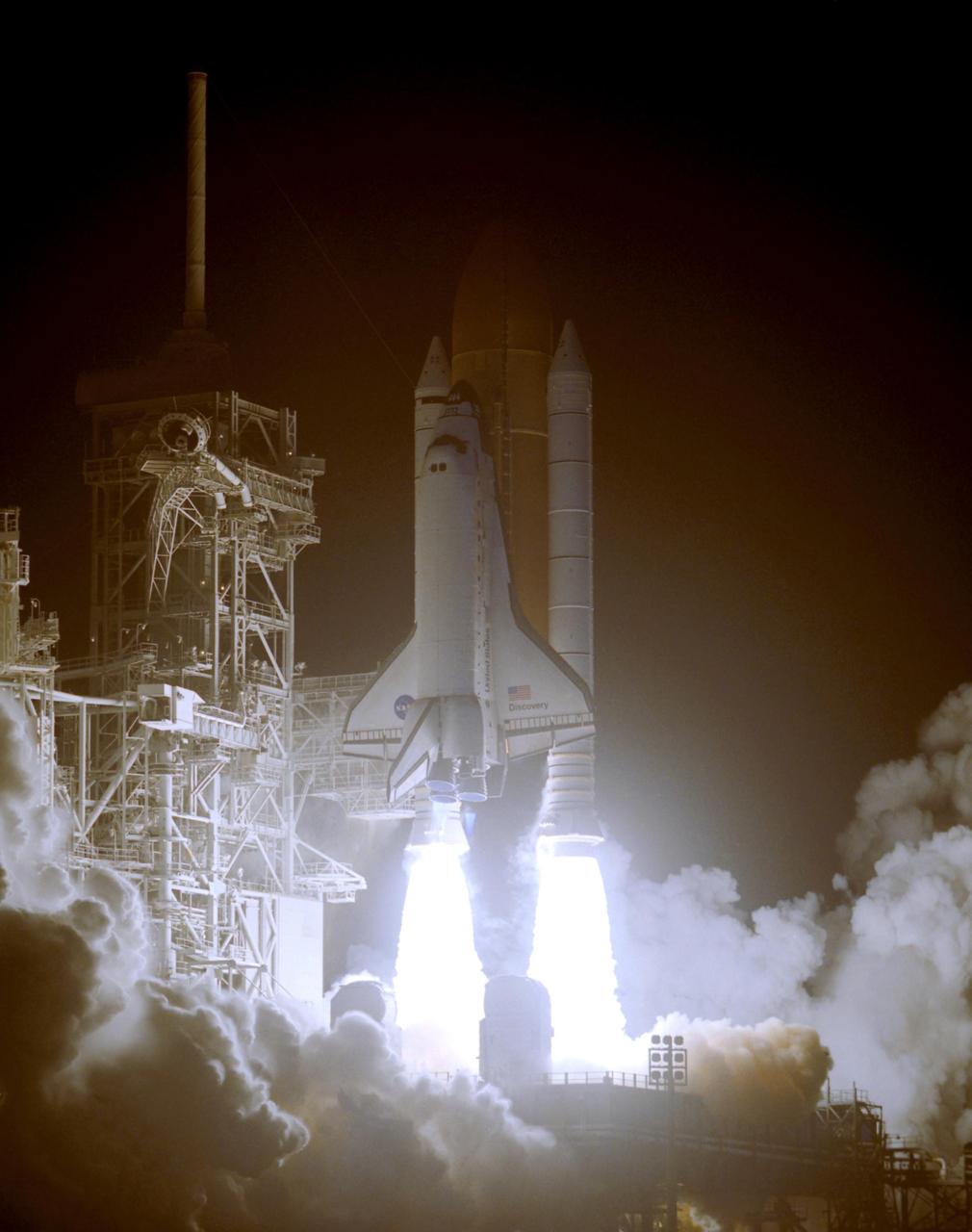KENNEDY SPACE CENTER, FLA. --   Space Shuttle Discovery seems to be standing on the fiery columns erupting from the solid rocket boosters as it lifts off Launch Pad 39B on mission STS-116. Liftoff occurred at 8:47 p.m. EST.  This was the second launch attempt for mission STS-116.  The first launch attempt on Dec. 7 was postponed due a low cloud ceiling over Kennedy Space Center. This is Discovery's 33rd mission and the first night launch since 2002.   The 20th shuttle mission to the International Space Station, STS-116 carries another truss segment, P5. It will serve as a spacer, mated to the P4 truss that was attached in September.  After installing the P5, the crew will reconfigure and redistribute the power generated by two pairs of U.S. solar arrays. Landing is expected Dec. 21 at KSC.   Photo credit: NASA/Regina Mitchell-Ryall & Tim Powers