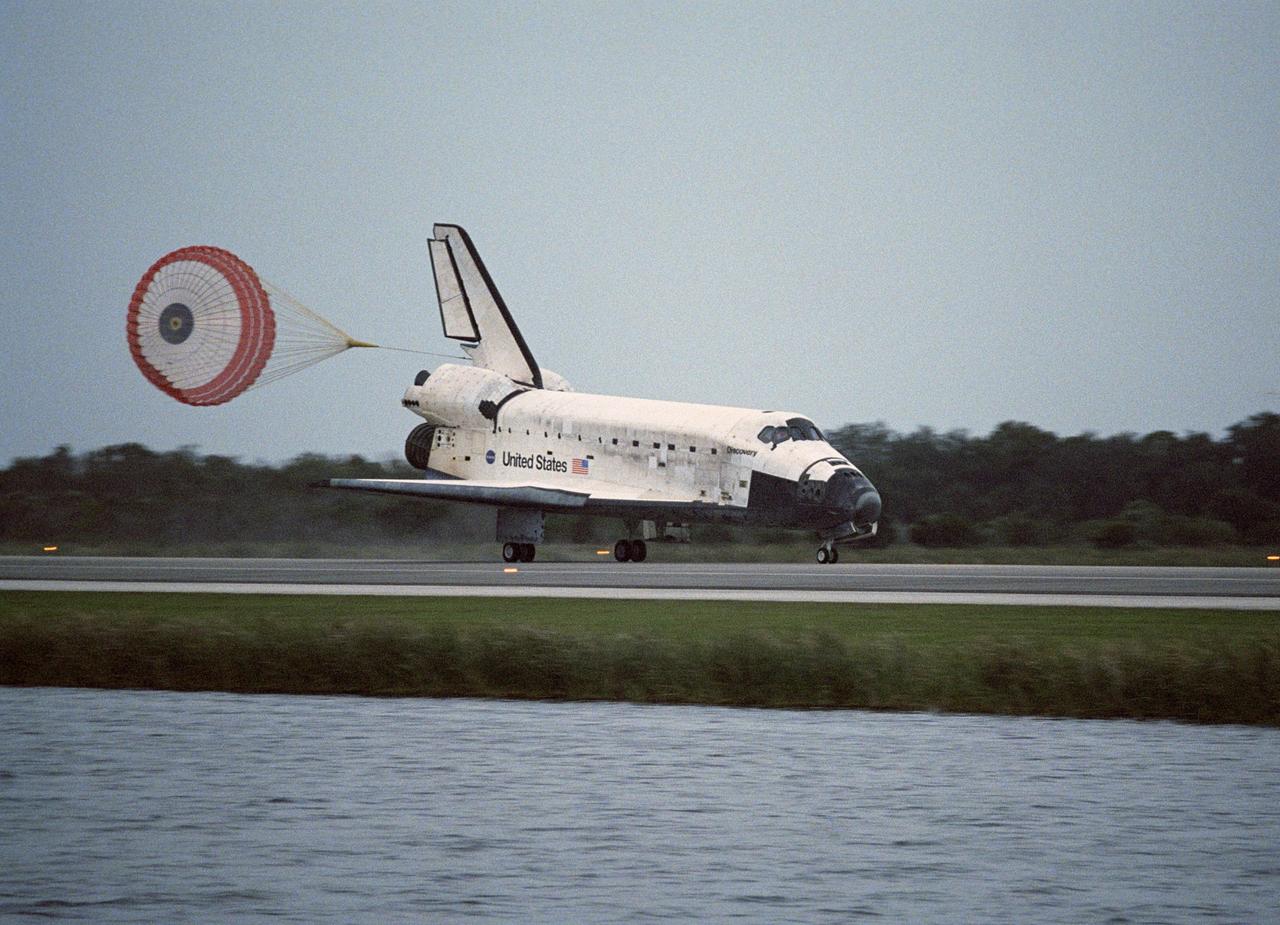 KENNEDY SPACE CENTER, FLA. -- The drag chute behind Space Shuttle Discovery helps slow the vehicle after touchdown on Runway 15 at NASA Kennedy Space Center's Shuttle Landing Facility, concluding mission STS-116. Main gear touchdown was at 5:32 p.m. EST. Nose gear touchdown was at 5:32:12 p.m. and wheel stop was at 5:32:52 p.m. At touchdown -- nominally about 2,500 ft. beyond the runway threshold -- the orbiter is traveling at a speed ranging from 213 to 226 mph. Discovery traveled 5,330,000 miles, landing on orbit 204. Mission elapsed time was 12 days, 20 hours, 44 minutes and 16 seconds. This is the 64th landing at KSC. Aboard Discovery are Commander Mark Polansky, Pilot William Oefelein, and Mission Specialists Robert Curbeam, Joan Higginbotham, Nicholas Patrick and Christer Fuglesang, who represents the European Space Agency, as well as Thomas Reiter, who is returning from a 6-month stay on the International Space Station. During the mission, three spacewalks attached the P5 integrated truss structure to the station, and completed the rewiring of the orbiting laboratory’s power system. A fourth spacewalk retracted a stubborn solar array.