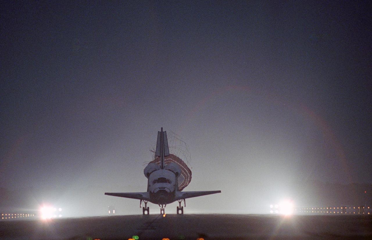 KENNEDY SPACE CENTER, FLA. -- The drag chute is released behind Space Shuttle Discovery as it touches down on an illuminated Runway 15 at NASA Kennedy Space Center's Shuttle Landing Facility, concluding mission STS-116. Main gear touchdown was at 5:32 p.m. EST. Nose gear touchdown was at 5:32:12 p.m. and wheel stop was at 5:32:52 p.m. At touchdown -- nominally about 2,500 ft. beyond the runway threshold -- the orbiter is traveling at a speed ranging from 213 to 226 mph. Discovery traveled 5,330,000 miles, landing on orbit 204. Mission elapsed time was 12 days, 20 hours, 44 minutes and 16 seconds. This is the 64th landing at KSC. Aboard Discovery are Commander Mark Polansky, Pilot William Oefelein, and Mission Specialists Robert Curbeam, Joan Higginbotham, Nicholas Patrick and Christer Fuglesang, who represents the European Space Agency, as well as Thomas Reiter, who is returning from a 6-month stay on the International Space Station. During the mission, three spacewalks attached the P5 integrated truss structure to the station, and completed the rewiring of the orbiting laboratory’s power system. A fourth spacewalk retracted a stubborn solar array.