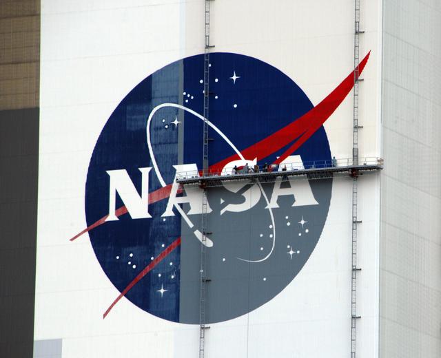 NASA image: Workers painting the Flag and Meatball on the VAB