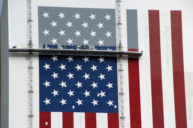 NASA image: Workers painting the Flag and Meatball on the VAB