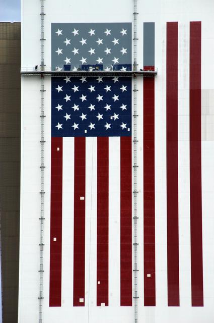 NASA image: Workers painting the Flag and Meatball on the VAB