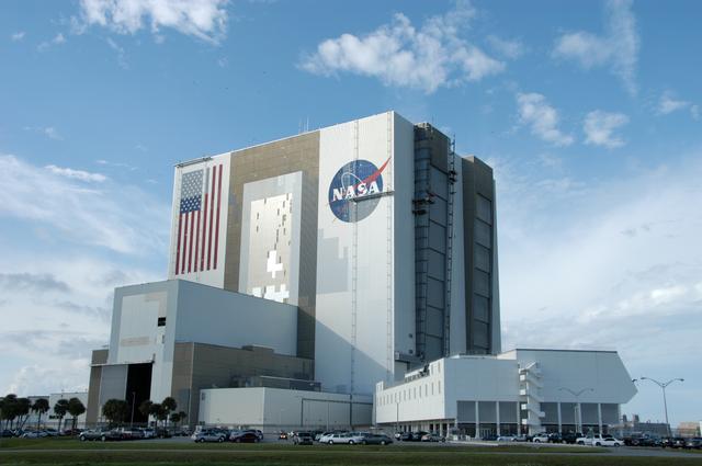 NASA image: Workers painting the Flag and Meatball on the VAB