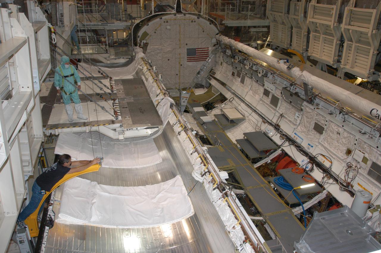 Endeavour's payload bay is open for payload configuration work in Orbiter Processing Facility bay 2. The orbiter is the vehicle designated for mission STS-118, scheduled to launch in late June. The mission will continue space station construction by delivering a third starboard truss segment, S5, as well as carrying the External Stowage Platform 3. The crew comprises six astronauts: Commander Scott Kelly, Pilot Charles Hobaugh and Mission Specialists Dr. Dafydd (Dave) Williams, Barbara Morgan, Richard Mastracchio and Tracy Caldwell. Williams represents the Canadian Space Agency.