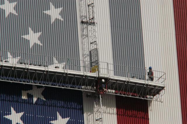 NASA image: Workers painting the Flag and Meatball on the VAB