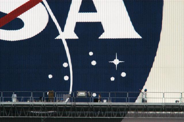 NASA image: Workers painting the Flag and Meatball on the VAB
