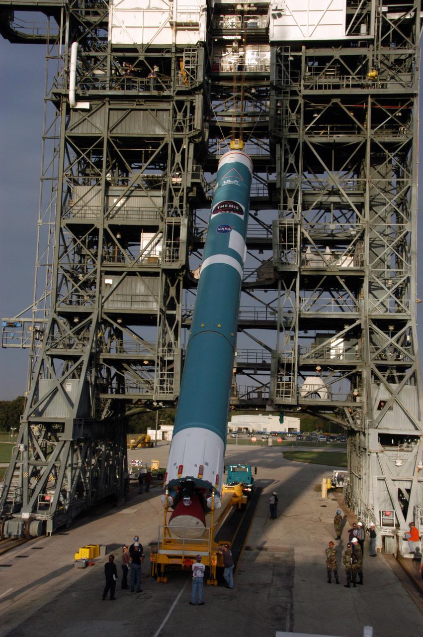 On Launch Pad 17-B at Cape Canaveral Air Force Station in Florida, the first stage of a United Launch Alliance Delta II rocket is raised off its transporter to a vertical position. The rocket will then be lifted into the mobile service tower. The rocket is the launch vehicle for the THEMIS spacecraft, consisting of five identical probes, the largest number of scientific satellites ever launched into orbit aboard a single rocket. This unique constellation of satellites will resolve the tantalizing mystery of what causes the spectacular sudden brightening of the aurora borealis and aurora australis - the fiery skies over the Earth's northern and southern polar regions. After the first stage is in the tower on the pad, nine solid rocket boosters will be placed around the base of the first stage and attached in sets of three. THEMIS is scheduled to launch aboard the Delta II at 6:07 p.m. EST on Feb. 15. 