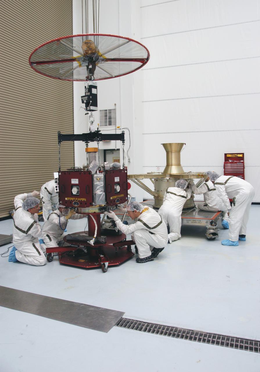 At Astrotech Space Operations, technicians adjust connections of the overhead crane on one of the THEMIS probes. The probe and its other four mates will be lifted and installed on the probe carrier in the background. The probes will then undergo spin-balance testing. THEMIS consists of five identical probes, the largest number of scientific satellites ever launched into orbit aboard a single rocket. This unique constellation of satellites will resolve the tantalizing mystery of what causes the spectacular sudden brightening of the aurora borealis and aurora australis - the fiery skies over the Earth's northern and southern polar regions. THEMIS is scheduled to launch Feb. 15 from Cape Canaveral Air Force Station. 