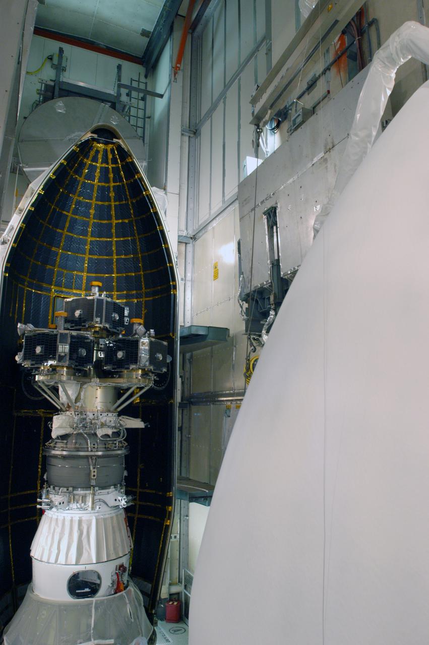 In the mobile service tower on Pad 17-B at Cape Canaveral Air Force Station, the second half of the fairing, at right, moves toward the waiting THEMIS spacecraft. The first half has already been put in place. The fairing is a molded structure that fits flush with the outside surface of the Delta II upper stage booster and forms an aerodynamically smooth nose cone, protecting the spacecraft during launch and ascent. THEMIS is an acronym for Time History of Events and Macroscale Interactions during Substorms. THEMIS consists of five identical probes that will track violent, colorful eruptions near the North Pole. This will be the largest number of scientific satellites NASA ever launched into orbit aboard a single rocket. The THEMIS mission aims to unravel the tantalizing mystery behind auroral substorms, an avalanche of magnetic energy powered by the solar wind that intensifies the northern and southern lights. The mission will investigate what causes auroras in the Earth’s atmosphere to dramatically change from slowly shimmering waves of light to wildly shifting streaks of bright color. Launch of THEMIS is scheduled for Feb. 15 aboard a Delta II rocket, with the launch service being conducted by the United Launch Alliance.