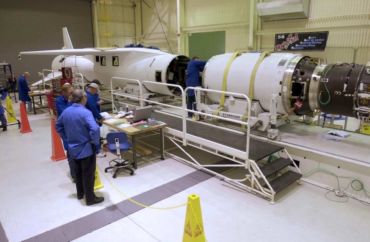 At Vandenberg Air Force Base in California, a technician on the work stand (center) prepares the second stage of the Orbital Sciences Pegasus XL rocket to be mated to the first stage, at left, for the launch of NASA's Aeronomy of Ice in the Mesosphere, or AIM, spacecraft. AIM is the seventh Small Explorers mission under NASA's Explorer Program. The program provides frequent flight opportunities for world-class scientific investigations from space within heliophysics and astrophysics. The AIM spacecraft will fly three instruments designed to study polar mesospheric clouds located at the edge of space, 50 miles above the Earth's surface in the coldest part of the planet's atmosphere. The mission's primary goal is to explain why these clouds form and what has caused them to become brighter and more numerous and appear at lower latitudes in recent years. AIM's results will provide the basis for the study of long-term variability in the mesospheric climate and its relationship to global climate change. AIM is scheduled to be mated to the Pegasus XL during the second week of April, after which final inspections will be conducted. Launch is scheduled for April 25.
