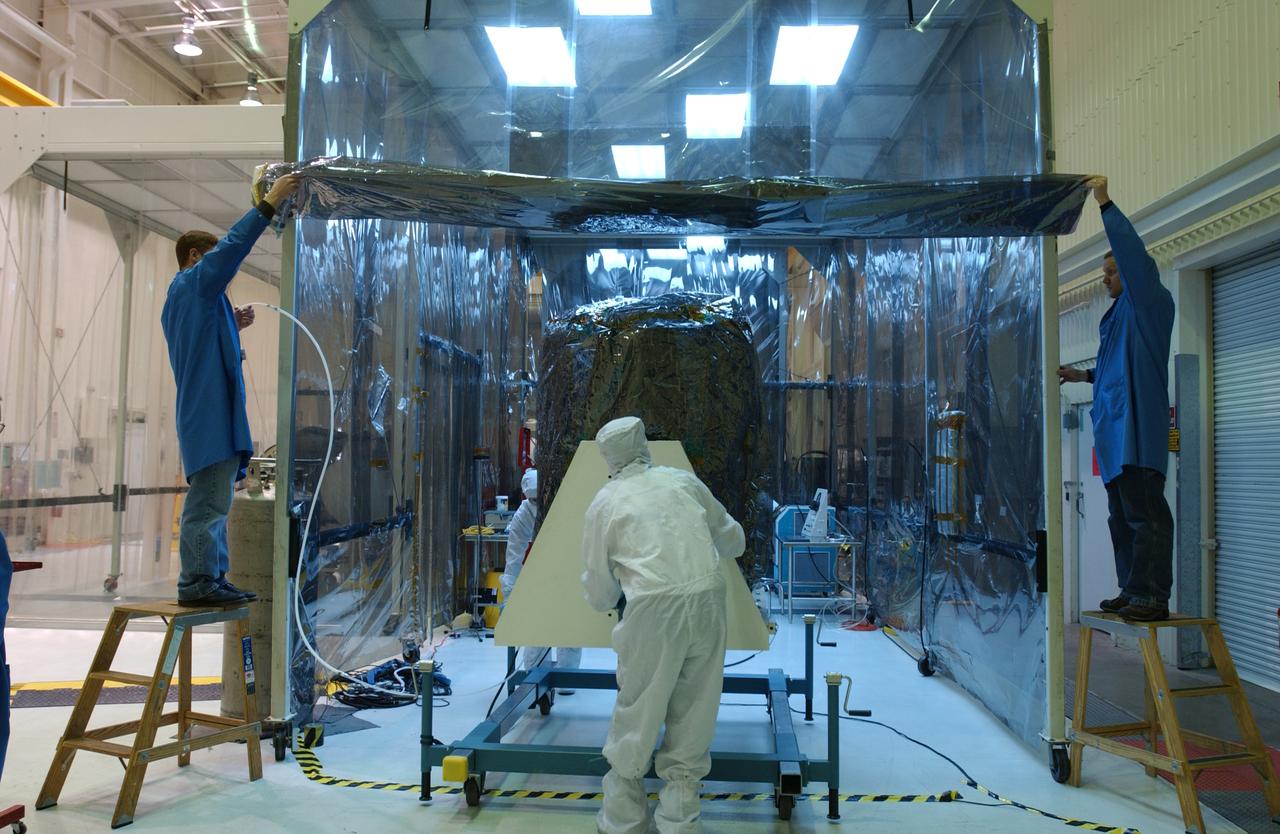 In Building 1555 at North Vandenberg Air Force Base, workers prepare the area where a partial deployment of the solar arrays on the AIM spacecraft will take place. The AIM spacecraft will fly three instruments designed to study polar mesospheric clouds located at the edge of space, 50 miles above the Earth's surface in the coldest part of the planet's atmosphere. The mission's primary goal is to explain why these clouds form and what has caused them to become brighter and more numerous and appear at lower latitudes in recent years. AIM's results will provide the basis for the study of long-term variability in the mesospheric climate and its relationship to global climate change. AIM is scheduled to be mated to the Pegasus XL during the second week of April, after which final inspections will be conducted. Launch is scheduled for April 25.