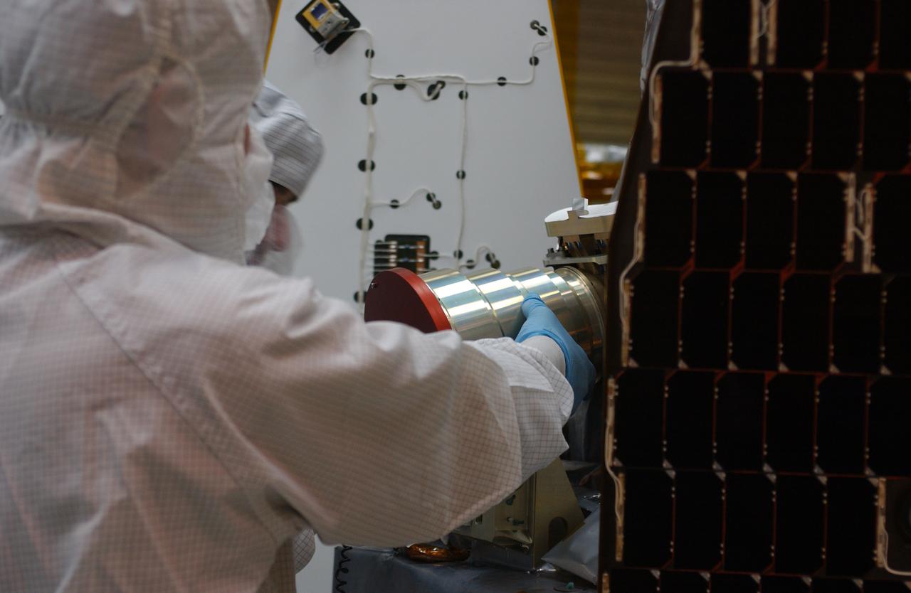 Inside the clean-room "tent" of Building 1555 at North Vandenberg Air Force Base, a technician places a star tracker cover on the AIM spacecraft during testing of the solar array panel deployment. The AIM spacecraft will fly three instruments designed to study polar mesospheric clouds located at the edge of space, 50 miles above the Earth's surface in the coldest part of the planet's atmosphere. The mission's primary goal is to explain why these clouds form and what has caused them to become brighter and more numerous and appear at lower latitudes in recent years. AIM's results will provide the basis for the study of long-term variability in the mesospheric climate and its relationship to global climate change. AIM is scheduled to be mated to its launch vehicle, Orbital Sciences' Pegasus XL, during the second week of April, after which final inspections will be conducted. Launch is scheduled for April 25.