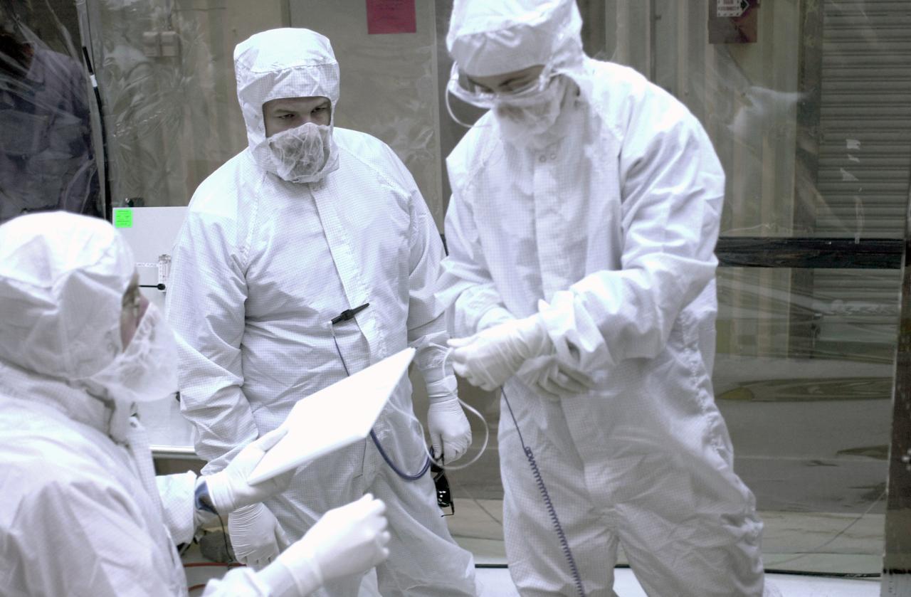In a clean-room environment at North Vandenberg Air Force Base, technicians look at part of the AIM spacecraft. AIM will fly three instruments designed to study polar mesospheric clouds located at the edge of space, 50 miles above the Earth's surface in the coldest part of the planet's atmosphere. The mission's primary goal is to explain why these clouds form and what has caused them to become brighter and more numerous and appear at lower latitudes in recent years. AIM's results will provide the basis for the study of long-term variability in the mesospheric climate and its relationship to global climate change. AIM is scheduled to be mated to the Pegasus XL during the second week of April, after which final inspections will be conducted. Launch is scheduled for April 25.