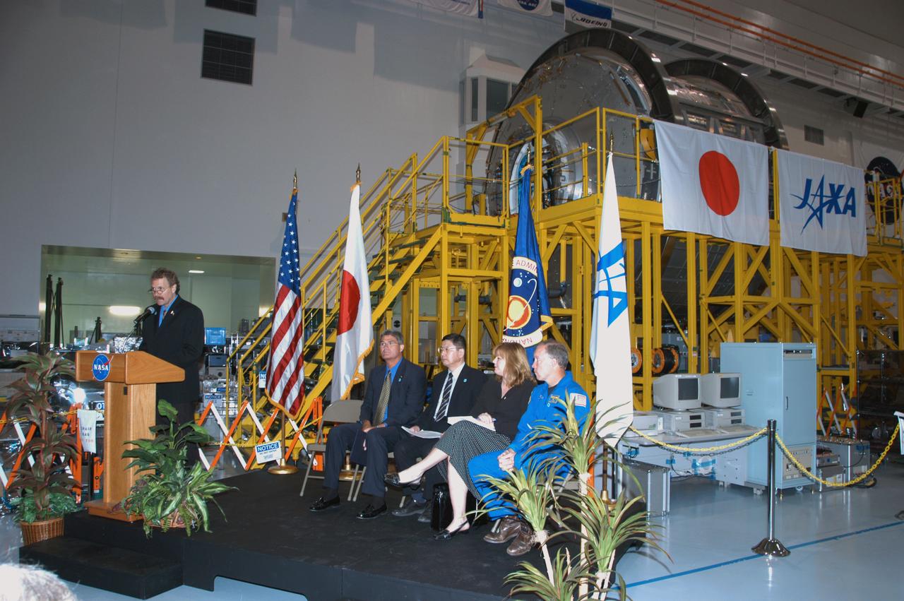 In the Space Station Processing Facility, NASA and Japanese Aerospace and Exploration Agency (JAXA) officials welcome the arrival of the Experiment Logistics Module Pressurized Section for the Japanese Experiment Module, or JEM, to the Kennedy Space Center. At the podium is Russ Romanella, director of International Space Station and Spacecraft Processing. Seated at right are Bill Parsons, director of Kennedy Space Center; Dr. Kichiro Imagawa, project manager of the JEM Development Project Team for JAXA; Melanie Saunders, associate manager of the International Space Station Program at Johnson Space Center; and Dominic Gorie, commander on mission STS-123 that will deliver the module to the space station. The new International Space Station component arrived at Kennedy March 12 to begin preparations for its future launch on mission STS-123. It will serve as an on-orbit storage area for materials, tools and supplies. It can hold up to eight experiment racks and will attach to the top of another larger pressurized module.