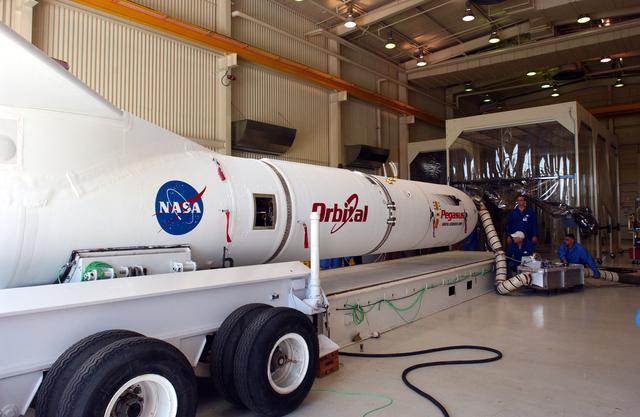 NASA image: The mated Pegasus XL rocket - AIM spacecraft leaves Building 165