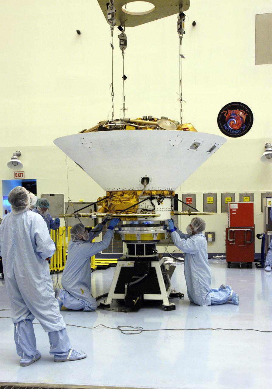 In the Payload Hazardous Servicing Facility, technicians secure the backshell with the Phoenix Mars Lander inside onto a spin table for spin testing. The Phoenix mission is the first project in NASA's first openly competed program of Mars Scout missions. Phoenix will land in icy soils near the north polar permanent ice cap of Mars and explore the history of the water in these soils and any associated rocks, while monitoring polar climate. Landing is planned in May 2008 on arctic ground where a mission currently in orbit, Mars Odyssey, has detected high concentrations of ice just beneath the top layer of soil. It will serve as NASA's first exploration of a potential modern habitat on Mars and open the door to a renewed search for carbon-bearing compounds, last attempted with NASA’s Viking missions in the 1970s. A stereo color camera and a weather station will study the surrounding environment while the other instruments check excavated soil samples for water, organic chemicals and conditions that could indicate whether the site was ever hospitable to life. Microscopes can reveal features as small as one one-thousandth the width of a human hair. Launch of Phoenix aboard a Delta II rocket is targeted for Aug. 3 from Cape Canaveral Air Force Station in Florida.