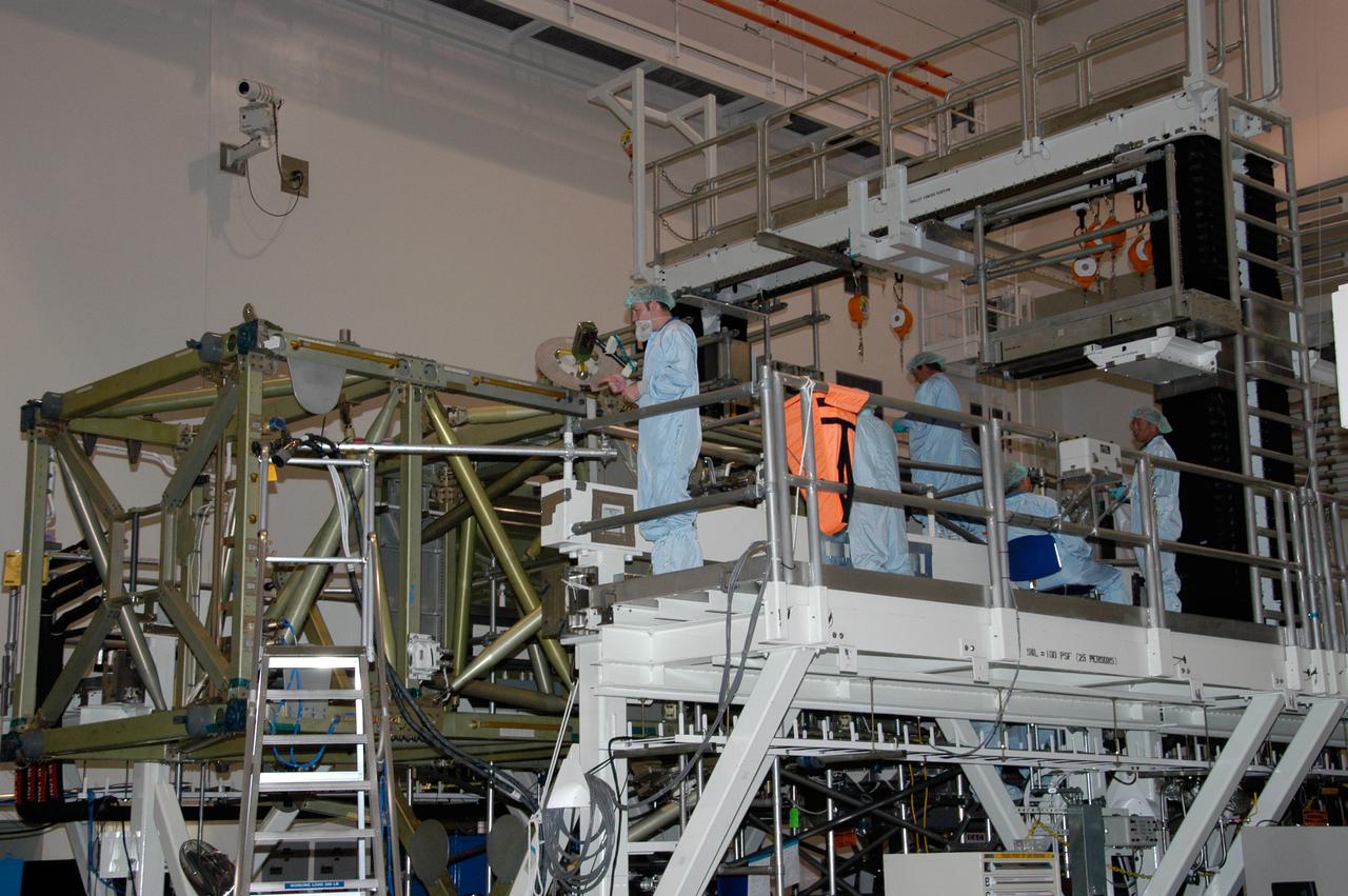 In the Space Station Processing Facility at NASA's Kennedy Space Center, workers prepare to connect cables that will recharge the battery for the S6 integrated truss. The final starboard truss in the assembly of the International Space Station, the S6 is scheduled to fly on space shuttle mission STS-119, whose launch date is not yet determined. 