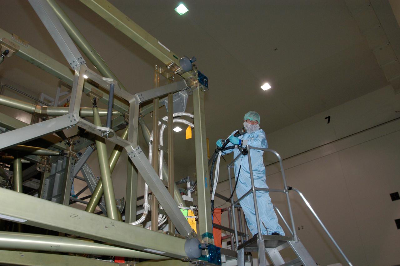 In the Space Station Processing Facility at NASA's Kennedy Space Center, a worker holds a cable that will help recharge the battery for the S6 integrated truss. The final starboard truss in the assembly of the International Space Station, the S6 is scheduled to fly on space shuttle mission STS-119, whose launch date is not yet determined.