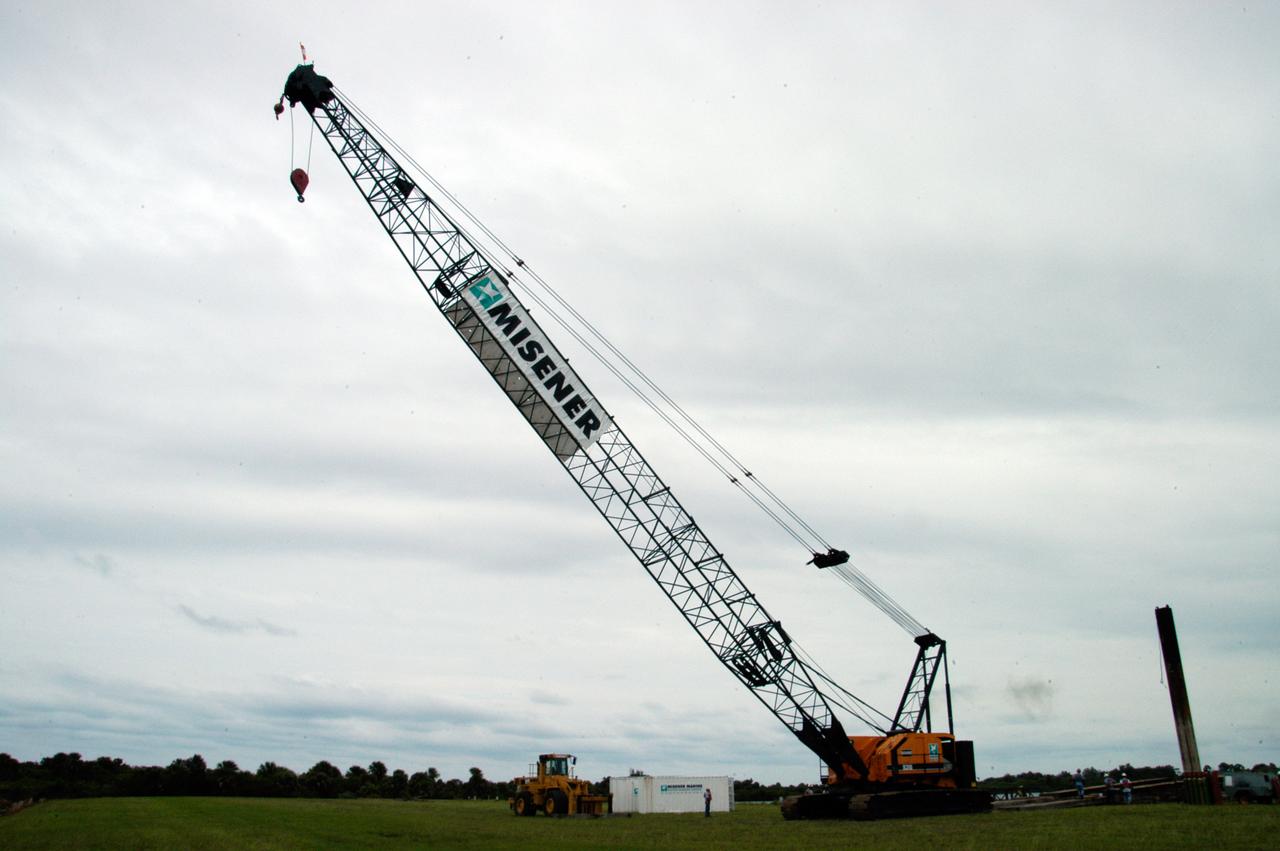 A large crawler crane begins moving away from the turn basin at the Launch Complex 39 Area on NASA's Kennedy Space Center. The crane with its 70-foot boom will be moved to Launch Pad 39B and used to construct a new lightning protection system for the Constellation Program and Ares/Orion launches. Pad B will be the site of the first Ares vehicle launch, including Ares I-X which is scheduled for April 2009.