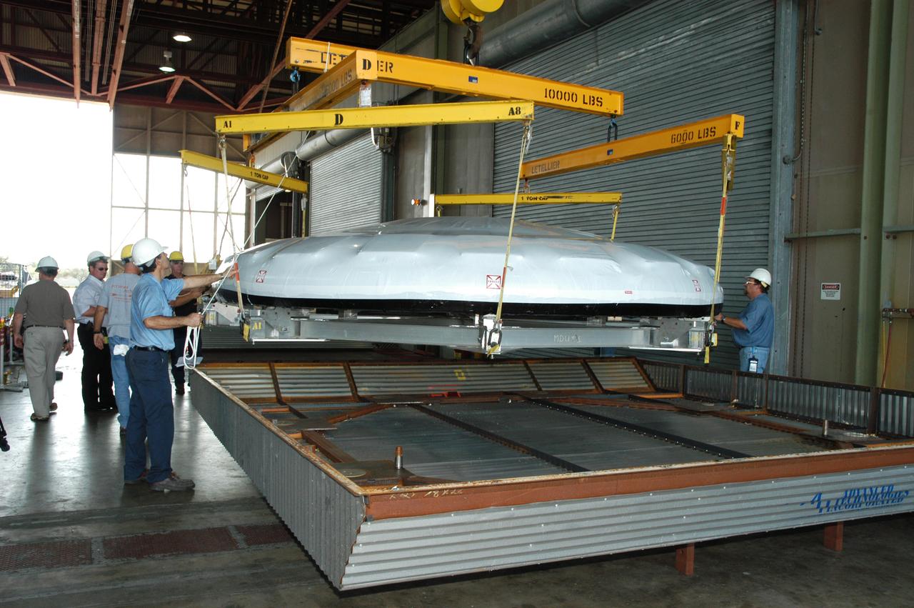 In Hangar N at NASA's Kennedy Space Center, a heat shield for the Constellation crew exploration vehicle, or CEV, is being prepared for a demonstration. A developmental heat shield for the Orion spacecraft is being tested and evaluated at Kennedy. The shield was designed and assembled by the Boeing Company in Huntington Beach, Calif., for NASA's Constellation Program. The thermal protection system manufacturing demonstration unit is designed to protect astronauts from extreme heat during re-entry to Earth's atmosphere from low Earth orbit and lunar missions. The CEV will be used to dock and gain access to the International Space Station, travel to the moon in the 2018 timeframe and play a crucial role in exploring Mars.